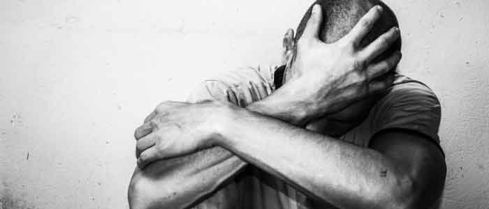 a man holding his head suffering from anxiety